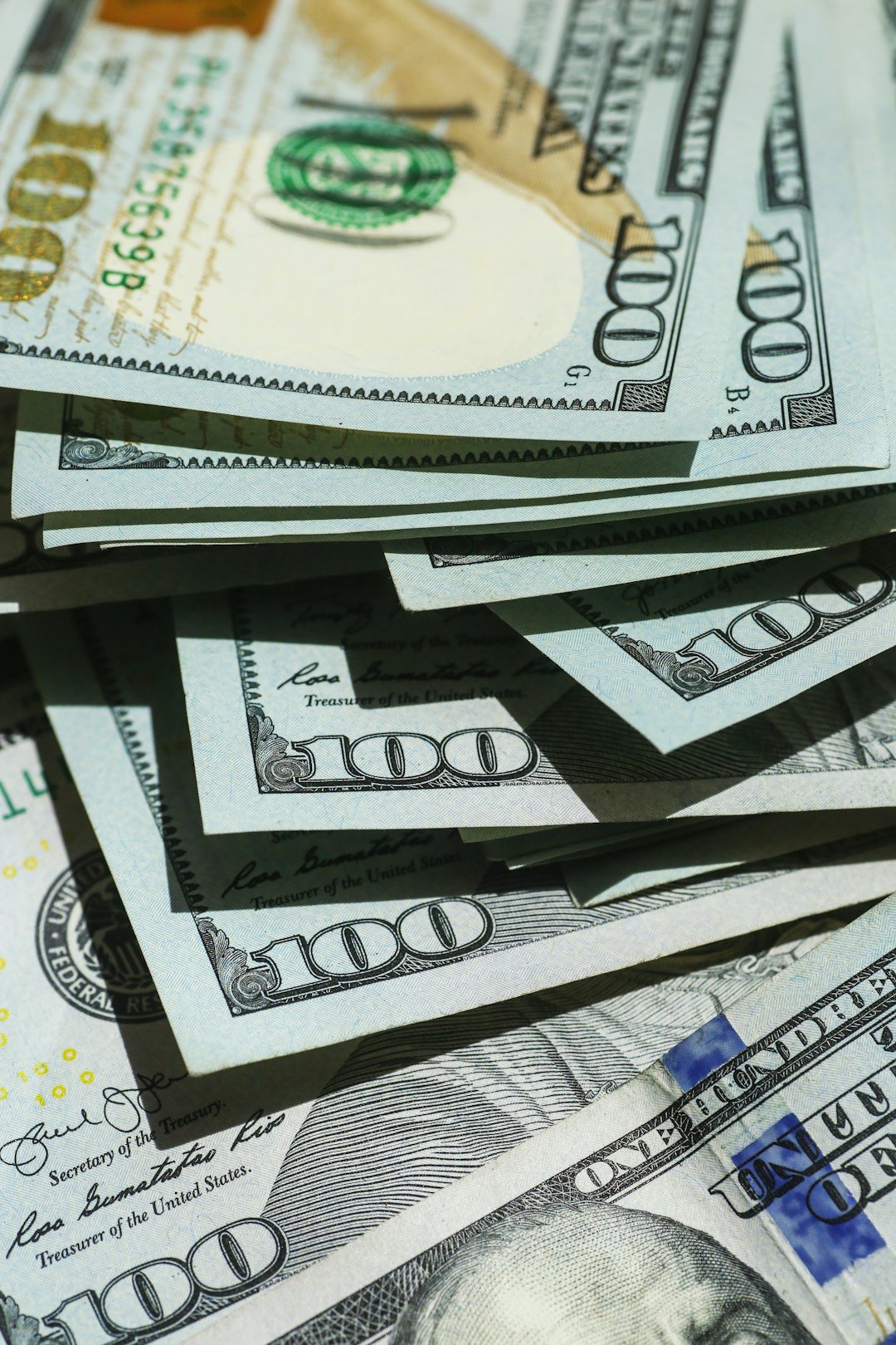 Close-up of stacked US dollar bills representing dollar strength and rising bond yields