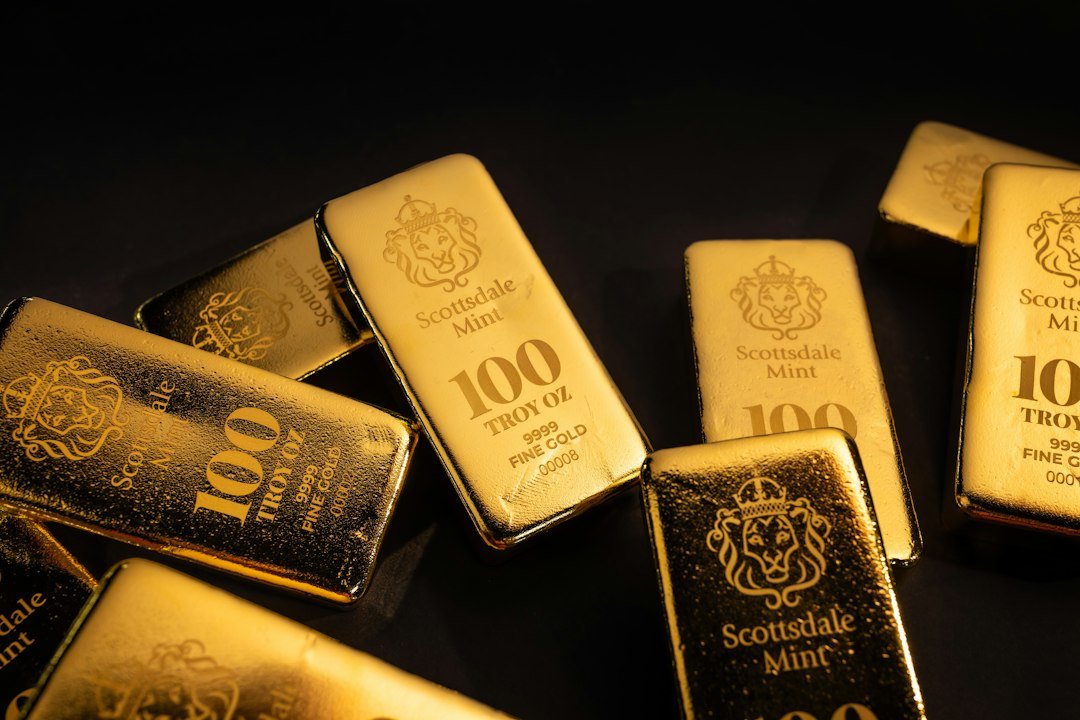 Gold bars scattered on a dark surface representing gold's reaction to the Fed's rate decision