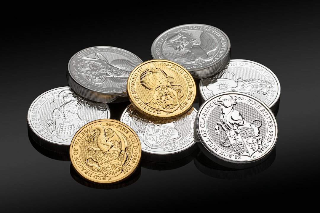 Silver and gold coins side by side representing a comparison of gold vs silver for trading