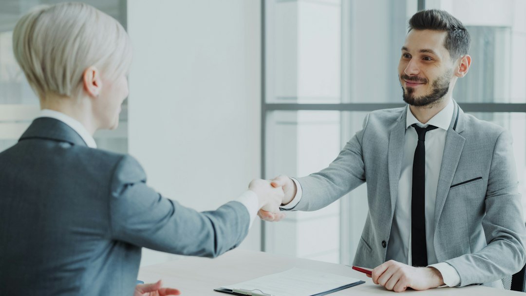 Two professionals shaking hands representing choosing between ECN and market maker forex brokers