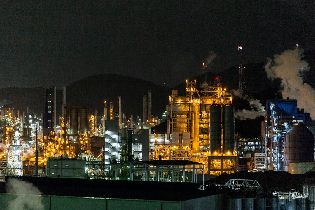 Industrial energy facility lit up at night representing oil supply risk after Houthi strikes on Saudi Arabia