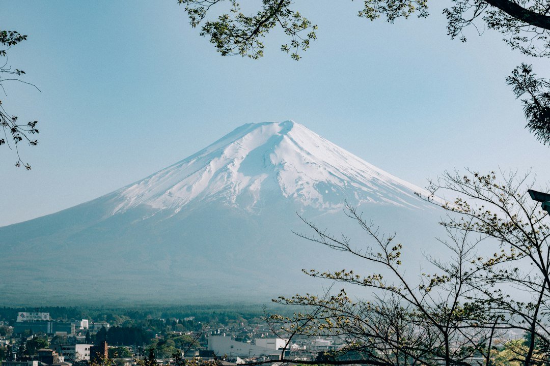 Mount Fuji rising above a town in Japan representing the Japanese yen near 158 per dollar